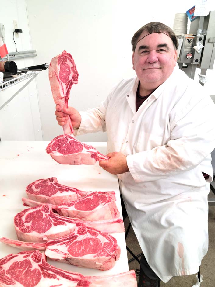 rome-country-meats-wisconsin-butcher-about Butcher holds custom cut Tomahawk beef steaks at Rome Country Meats and Deli Full-Service Butcher Shop in Nekoosa, WI